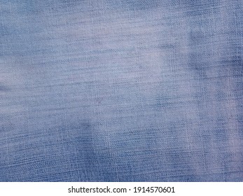 Blue denim background with beautiful patterns in vintage style. Close up jean fabric texture with space for graphics design or wallpaper. Classic clothing fashion details for the template.