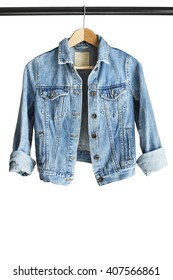 Blue Denim Jacket Hanging On Clothes Rack Isolated Over White