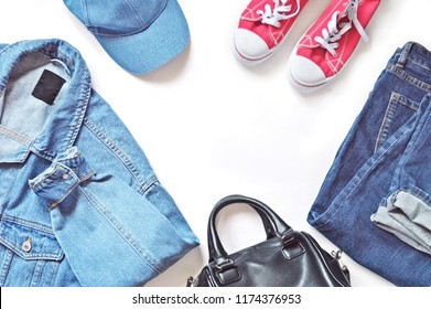 Blue Denim Jacket, Jeans, Cap, Red Gumshoes And Bag On A White Background. Flat Lay Clothes Photo. 90s Fashion Style