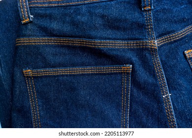 Blue Denim Jeans Back Pocket With Orange Thread Protruding Stitching