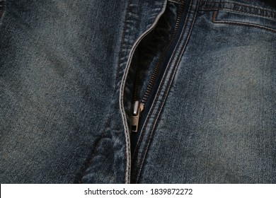 Blue denim jeans texture background with seam and orange thread stitches.                               