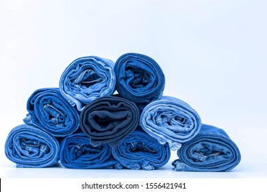 Blue denim jeans texture. Stacked of rolled of blue jeans background