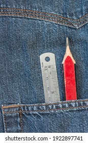 Blue Denim Shirt Pocket With Carpenters Pencil And Steel Rule. Close Up View.