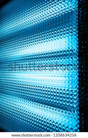 blue diagonal lines inside big movie lamp
