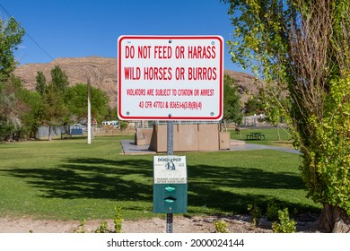 Blue Diamond, NV, USA – June 8, 2021: A Sign Reading Do Not Feed Or Harass Wild Horses Or Burros Posted At A City Park At Blue Diamond, Nevada.