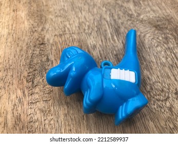 Blue Dino Toy With Object Out Of Focus