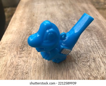 Blue Dino Toy With Object Out Of Focus