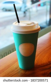 Blue Disposable Paper Cup For Coffee, Stands On The Table Near The Window In The Cafe, Outside The Car Window. Logo Mockup