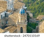 Blue dome of the Baroque style Chiesa di Santa Maria dell’Itria covered with eight Caltagirone terracotta panels decorated with large rococo flower vases in Ragusa Ibla Sicily Italy.