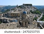 Blue dome of the Baroque style Chiesa di Santa Maria dell’Itria covered with eight Caltagirone terracotta panels decorated with large rococo flower vases in Ragusa Ibla Sicily Italy.