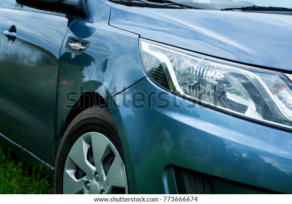 Blue\
door car with damage in an accident with a dent on the right side.\
How to apply for auto insurance in case of\
accident.