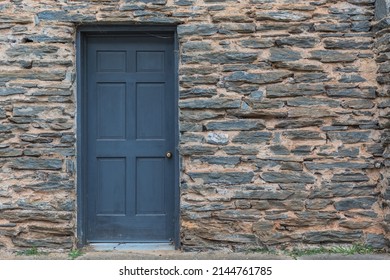 Blue Door In Of A House With Stone Wall