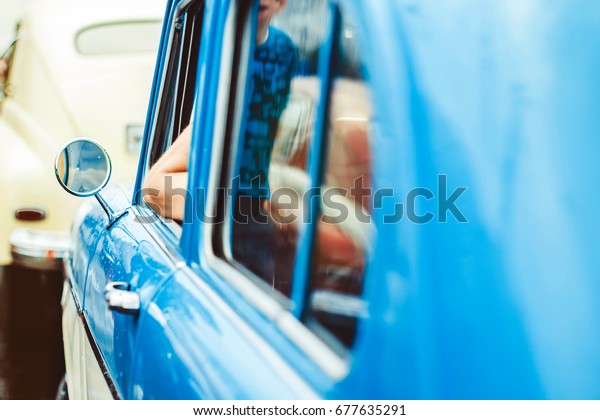 The blue door of an old\
Soviet car