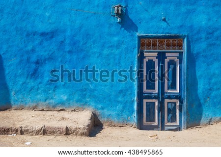 Blue doors on typical colourful house in Luxor, Egypt.