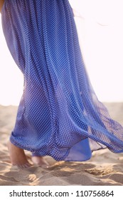 blue dress developing on the wind. sunset