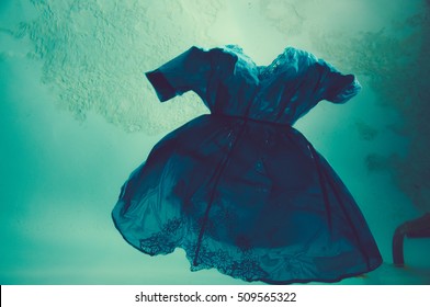 Blue Dress Floating In Pool