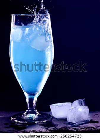 Blue drink with splash on black background. Cocktail card 2.