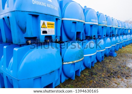 Blue drinking water storage tanks (bowsers) in storage awaiting deployment in an emergency water shortage situation