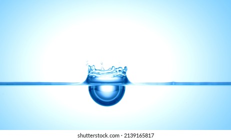 Blue drop falls down on blue transparent liquid creating a crown on it's surface | Abstract skin moisturizing cosmetics mixing concept - Shutterstock ID 2139165817
