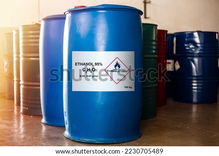 Blue drum size 160 kg of ethanol 95 percentage with the label of flammable liquid show caution for use. In addition, has a chemical barrel of other solvents beside it.