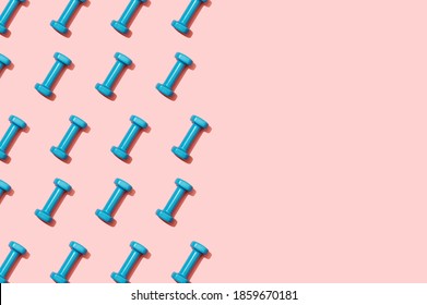 Blue Dumbbells For Home Workouts On A Pink Top View Background. Pattern. Equipment For Home Fitness Exercises. Women's Accessory For A Healthy Lifestyle, Sports. Sports Training With Weights