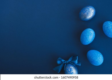 Blue easter eggs painted by hand on a dark background. Easter stylish minimal composition. Top view, flat lay, copy space