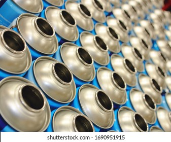 Blue Empty Aerosol Cans In Rows On Production Line