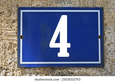 A blue enamel house number plaque, showing the white coloured number 4 (number four)