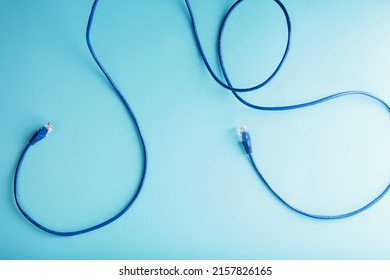 Blue Ethernet Cable Connectors Patch cord cord close-up isolated on a blue background with free space