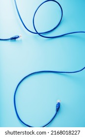 Blue Ethernet Cable Connectors Patch cord cord close-up isolated on a blue background with free space