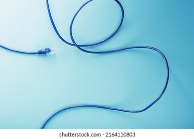 Blue Ethernet Cable Cord Patch cord on a blue background with free space