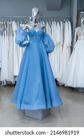 blue evening dress on mannequin for party bridesmaid wedding in bridal shop. fashion concept