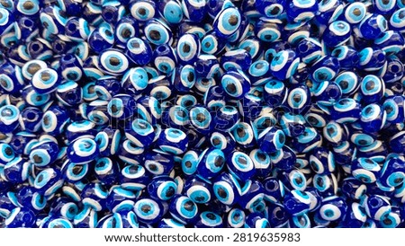 Blue Evil Eye Beads Background Pattern. Traditional Turkish Nazar Amulet Texture. evil eye, nazar, nazar bead, turkey, turkish, blue, background, pattern, texture, amulet, protection, symbol, culture, traditional, decorative, ornament, glass, bead, lucky charm, spirituality, belief, talisman, detail, close up, macro, repetition, design, abstract, full frame, vibrant, glossy, handmade, souvenir, market, craft, ethnic, folklore, middle east, mediterranean, pattern background, texture background, blue color, cultural symbol, no people, tourism, decorative art, wall decor, repeating pattern, artistic, spiritual