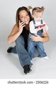 blue eye baby girl talking on call phone with her mother
