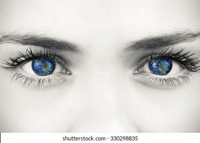 Blue eyes on grey face against earth