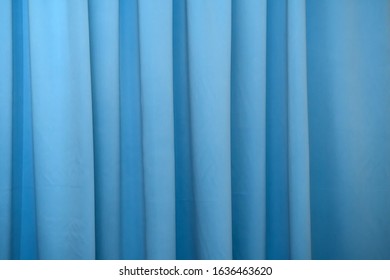 Blue Fabric Curtain On The Window. Background Drape Turquoise Canvas.