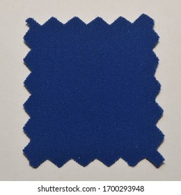 Blue Fabric Swatch Cut With Zig Zag Scissors.