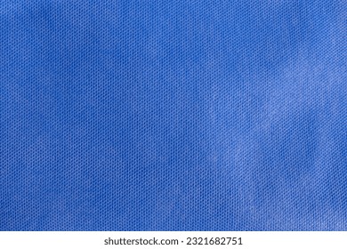 Blue fabric texture. Medical texture. Blue background. Surgical drape.. Closeup Image Of Blue Drape Sheet Using For Wrap Medical Surgical Instrument Before Sterilization.  Blue Drape Sheet.