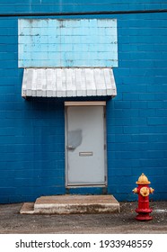 Blue Facade Old Pittsburgh Building With Red And Yellow Fire Hydrant