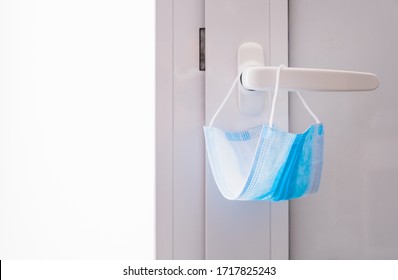 Blue Face Mask Hanging On The Door Knob