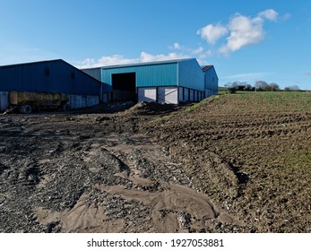 Blue Farm Buildings With A Slurry Tanker In Shadow In Herefordshire, England, UK.