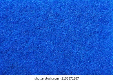 Blue fiber polishing pads textured background, Texture of a abrasive scourer dishwashing sponge. Background of a scrub cleaning sponge close up.                                     - Powered by Shutterstock