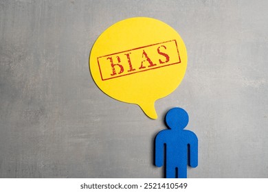 Blue figurine and a yellow speech bubble with red stamped word “BIAS”. Opinion, prejudice, judgement concept. - Powered by Shutterstock