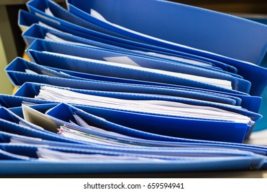 Blue File Folder Documents In A File Cabinet . Retention Of Contracts - Concept