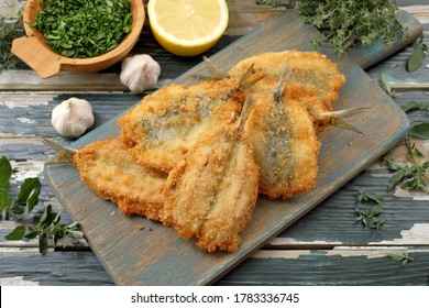 blue fish fried  pilchard on green table background