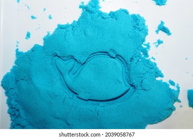 Blue Fish From Kinetic Sand On A White Tray. Top View