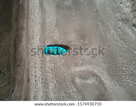 Blue fishing boat seen from above