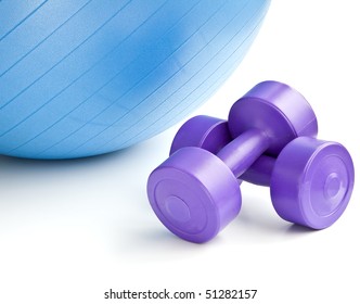 A blue fitness ball and a pair of dumbbells