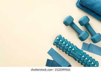 Blue fitness equipment for workout on pastel beige table. Top view. - Shutterstock ID 2123399561