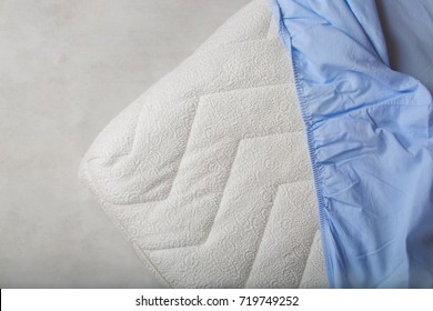 Blue Fitted Sheet On A Mattress. Top View. Closeup